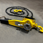 Yellow chain hoist on a gray concrete floor