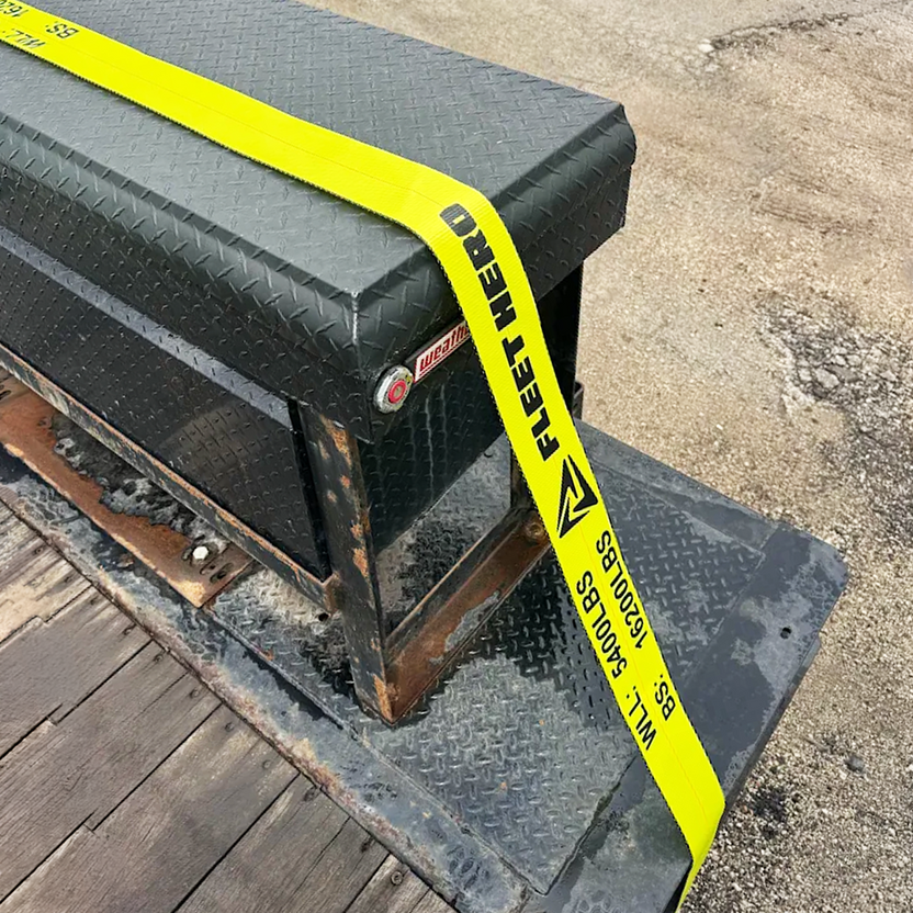 Black toolbox with yellow 'Fleet Hero' tape on a concrete surface