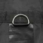 Close-up of a black bag with a silver buckle on a black background